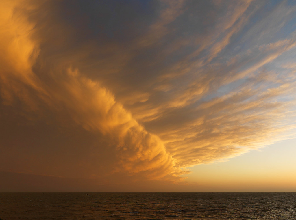 Sweeping golden clouds above the sea